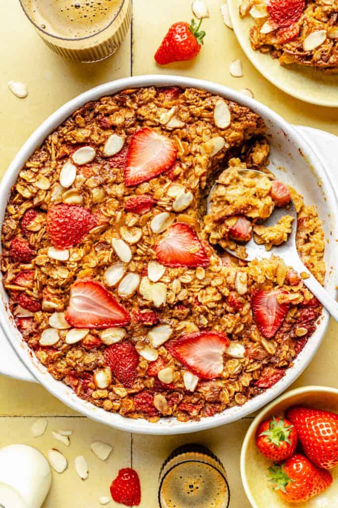 baked oatmeal in baking dish with serving spoon