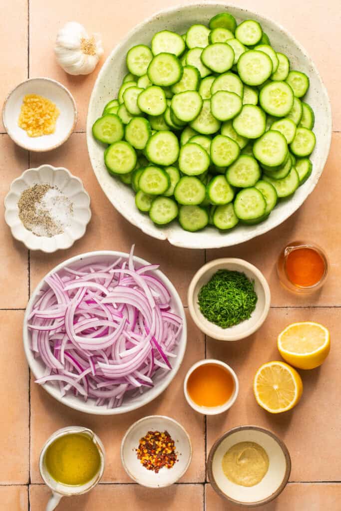 cucumber onion salad ingredients in small bowls