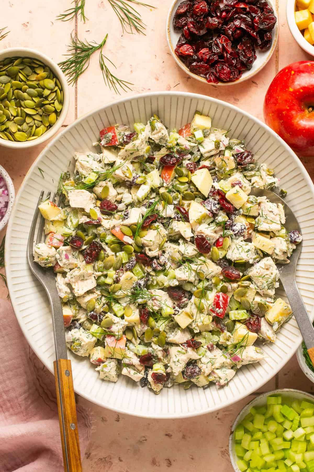 rotisserie chicken salad in serving bowl with serving tools