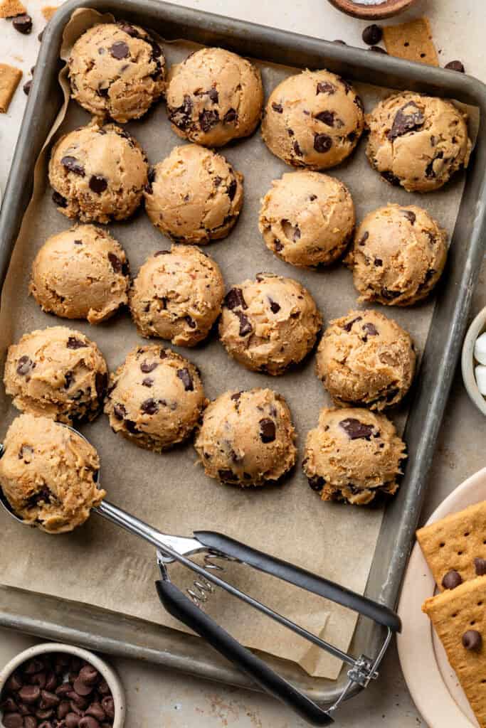 scoops of cookie dough on sheet pan