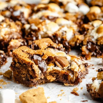 s'mores bar with a bite out on parchment paper