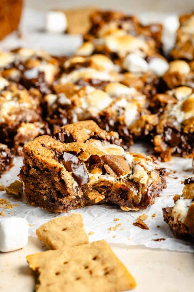 s'mores bar with a bite out on parchment paper