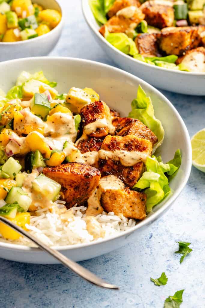 salmon in bowl with fork and toppings