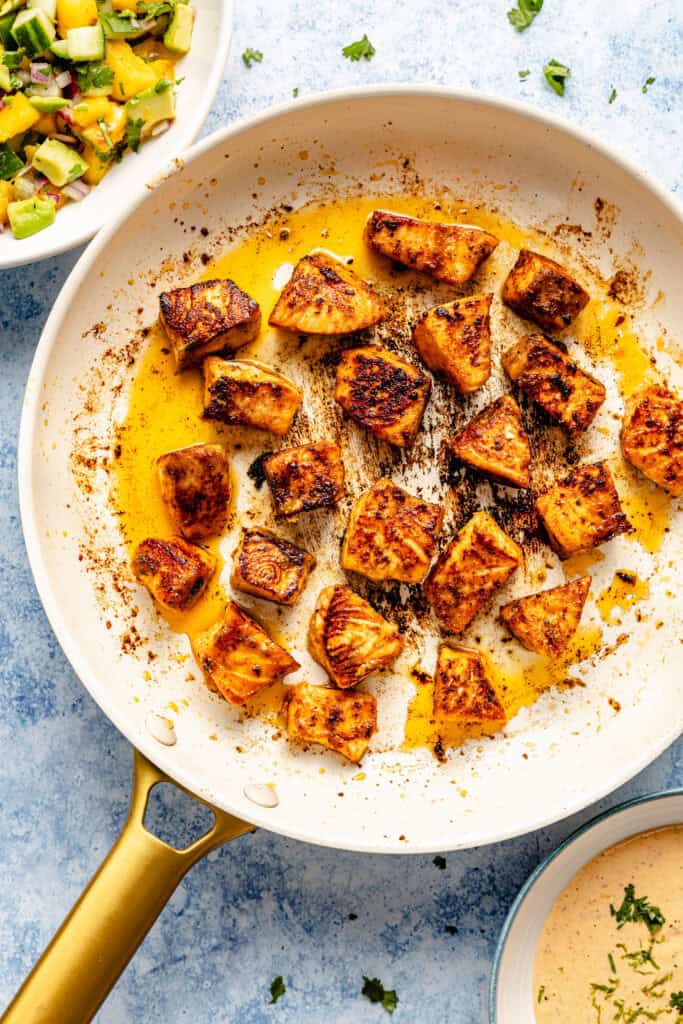 salmon bits cooking in skillet