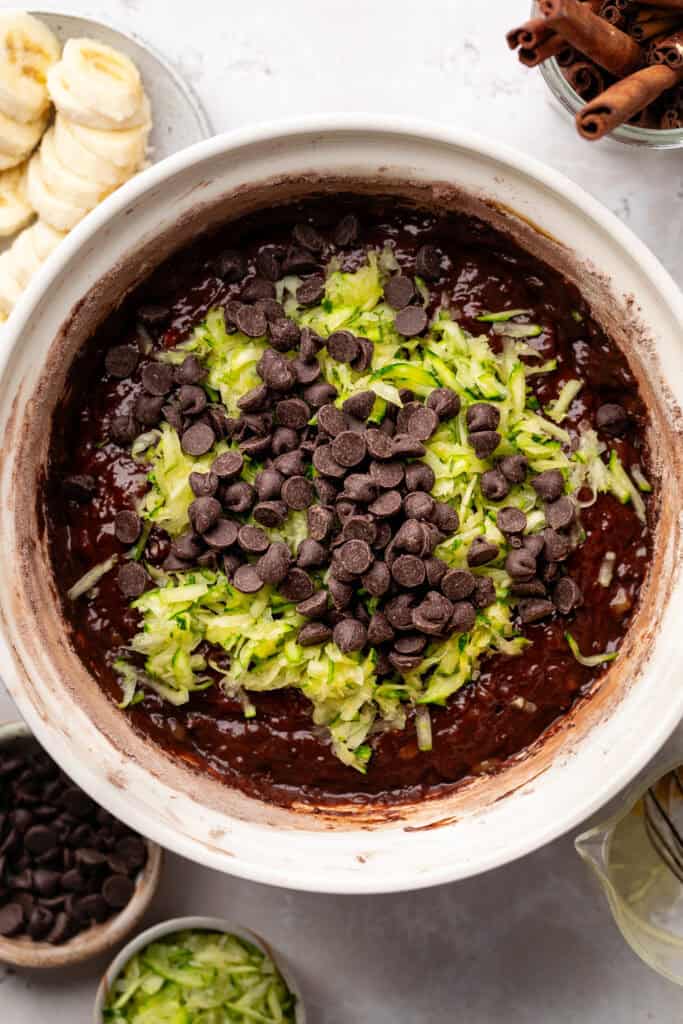 chocolate chips and zucchini being added to batter