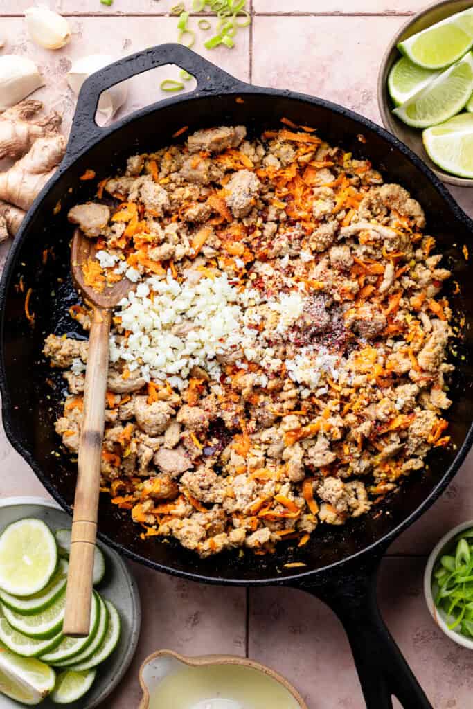 ground turkey and veggie mixture in skillet with spoon