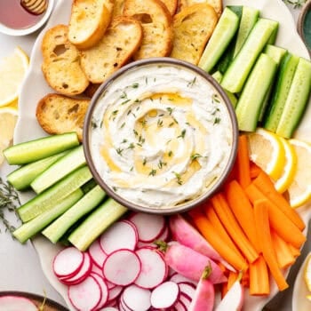 whipped goat cheese in bowl with veggies and bread