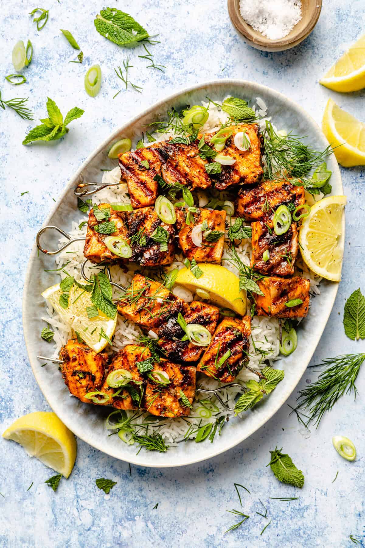 salmon over a bed of rice with lemons