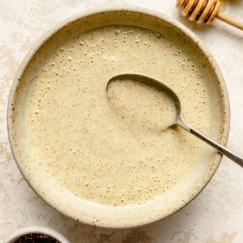 honey mustard dressing in bowl with spoon