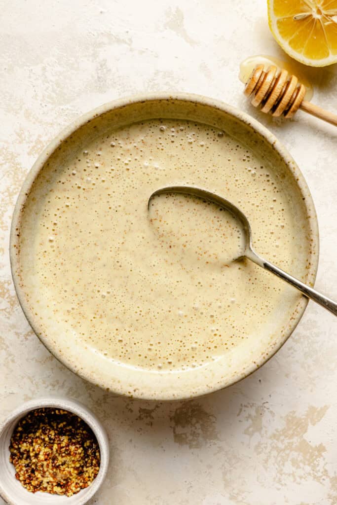 honey mustard dressing in bowl with spoon