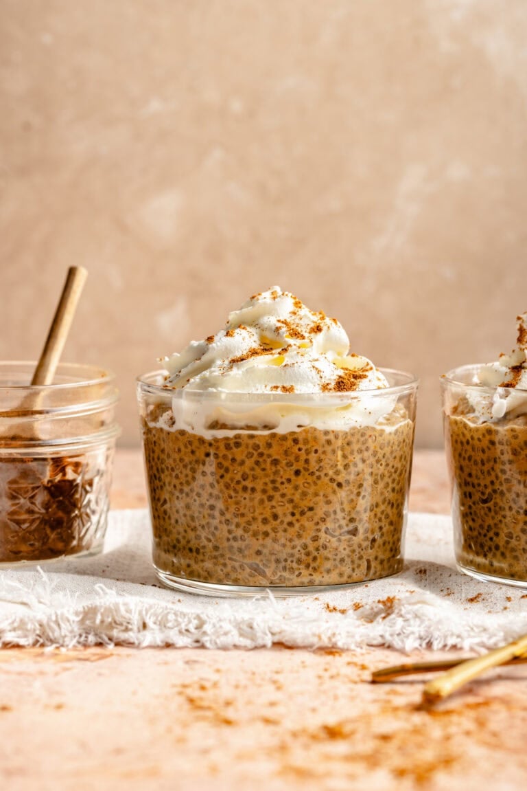 pumpkin chia pudding topped with whipped cream in a glass