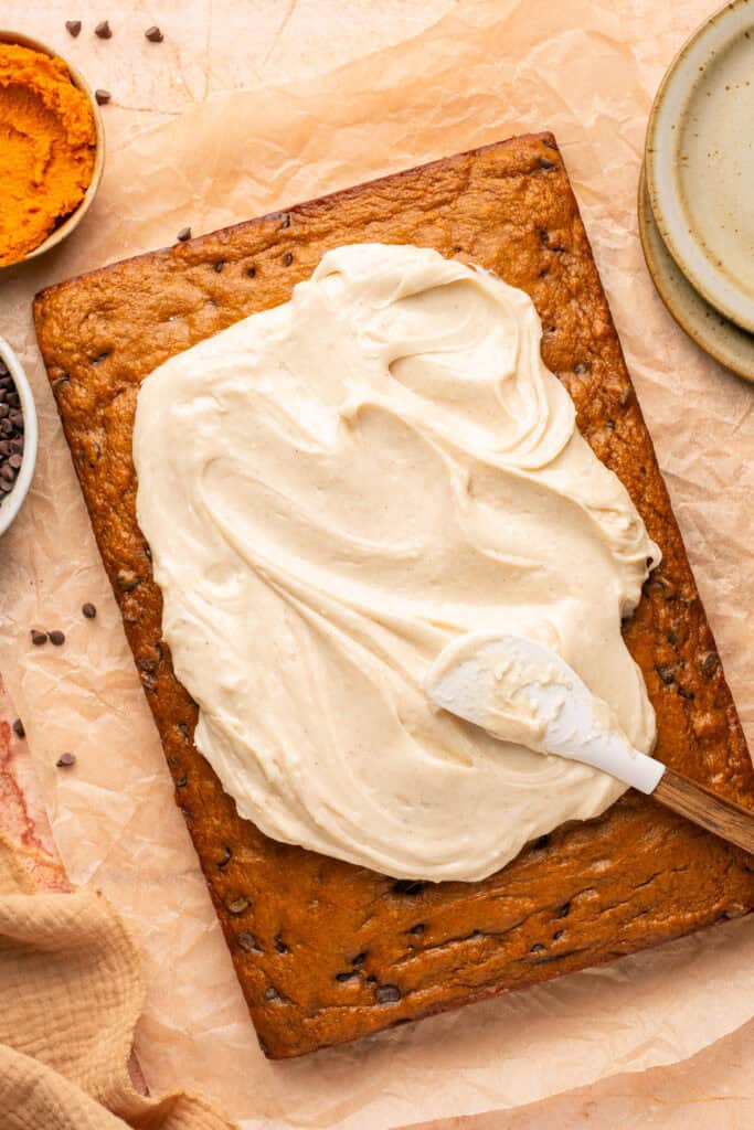 cream cheese being spread on cake