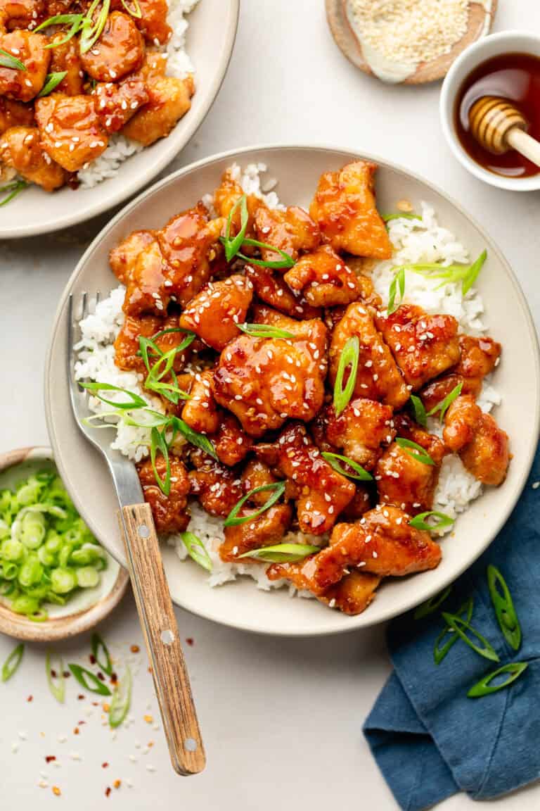 crispy honey garlic chicken in bowl over rice