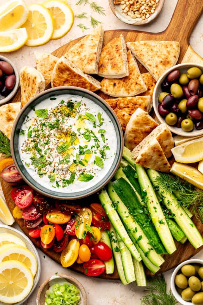 labneh dip with toppings served with veggies and pita