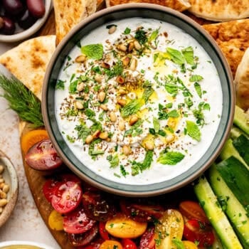 labneh dip with toppings served with veggies and pita