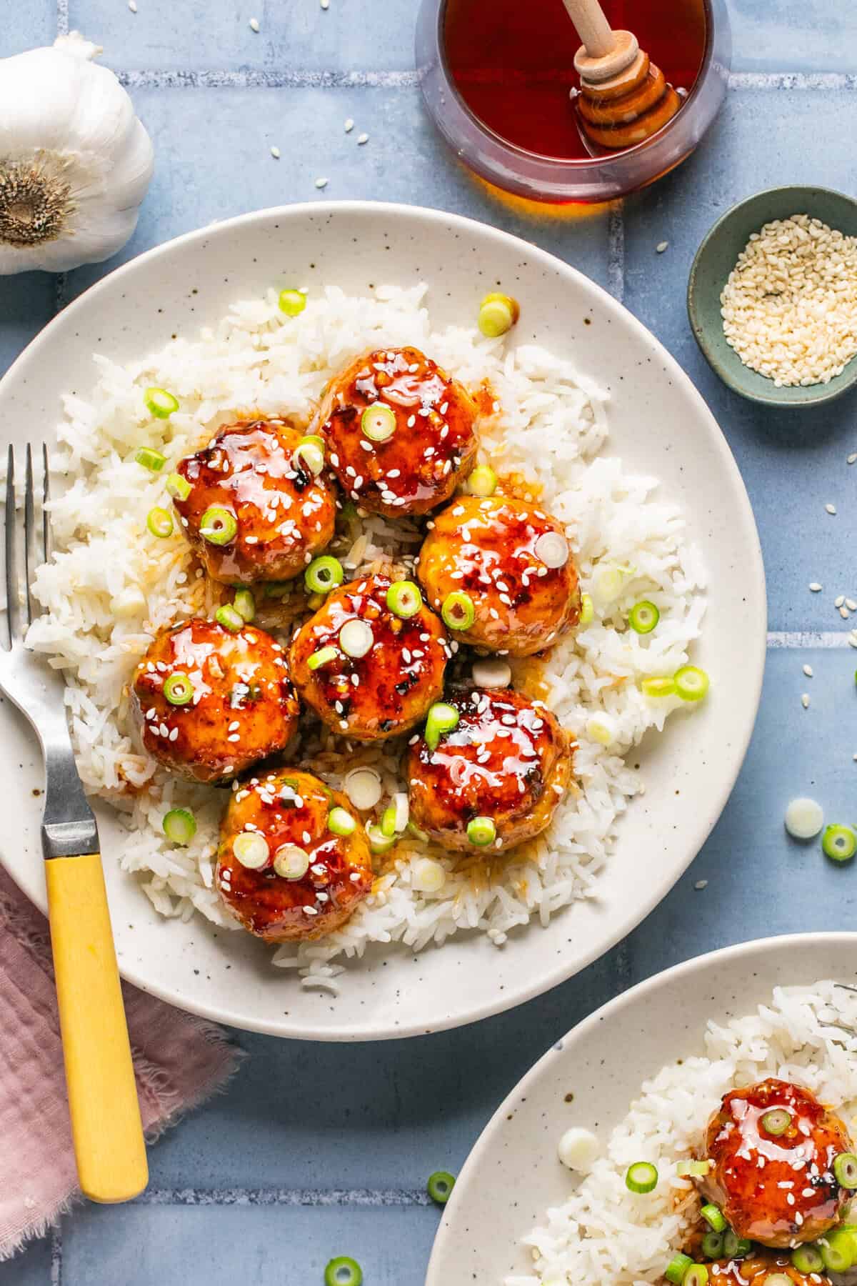 honey garlic meatballs over rice with fork