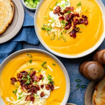 sweet potato soup in two bowls with toppings