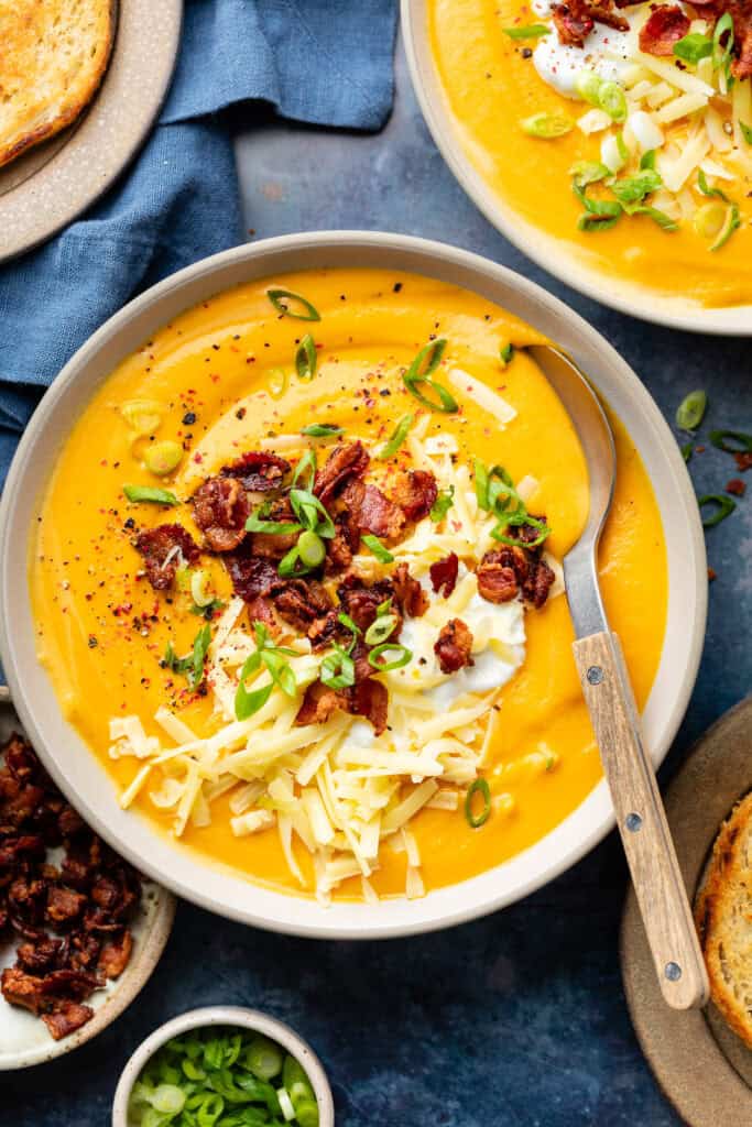 bowl of soup with toppings and spoon