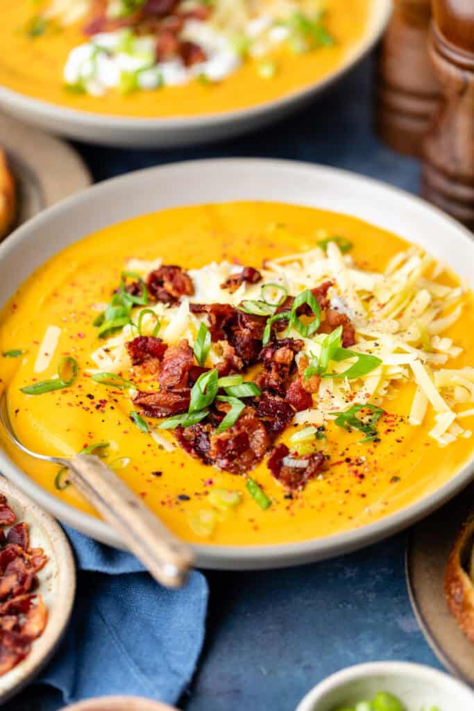 bowl of soup with toppings and spoon