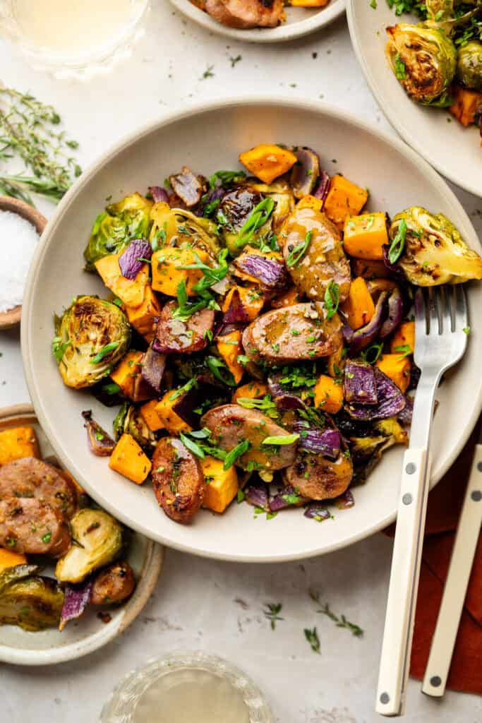 fall sheet pan dinner in bowl with fork