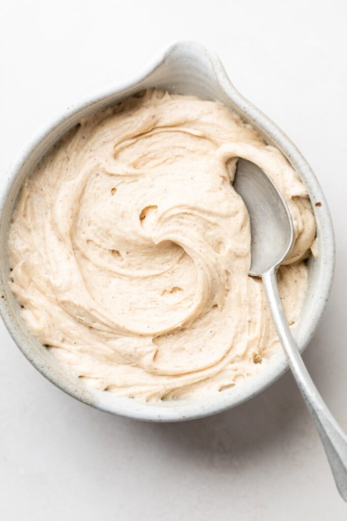 cream cheese frosting in bowl with spoon