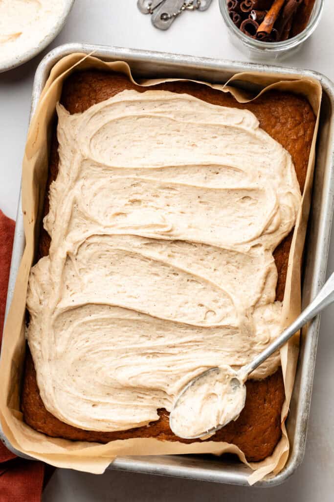 frosting being spread over cake