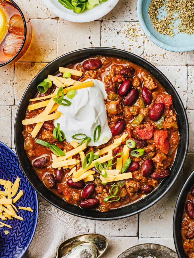 pumpkin chili in bowl with topping