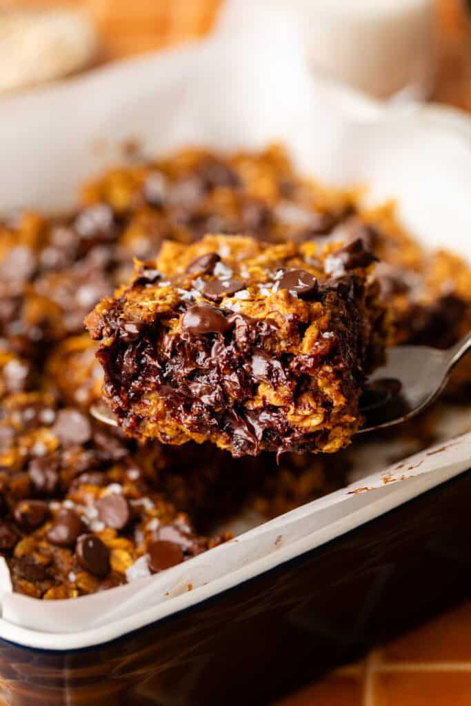 pumpkin oatmeal bar being lifted out of pan