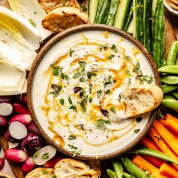 whipped ricotta in serving bowl with veggies and crostini