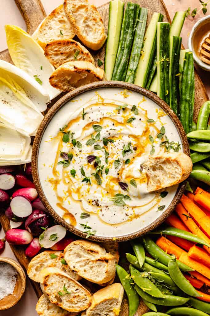 whipped ricotta in serving bowl with veggies and crostini