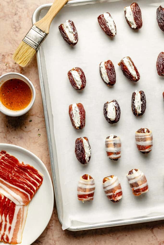 stuffed dates on baking sheet lined wit parchment