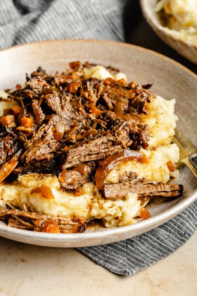 slow cooked beef over mashed potatoes