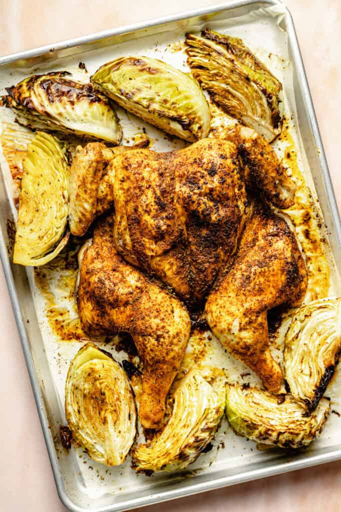 roasted whole chicken on sheet pan with cabbage