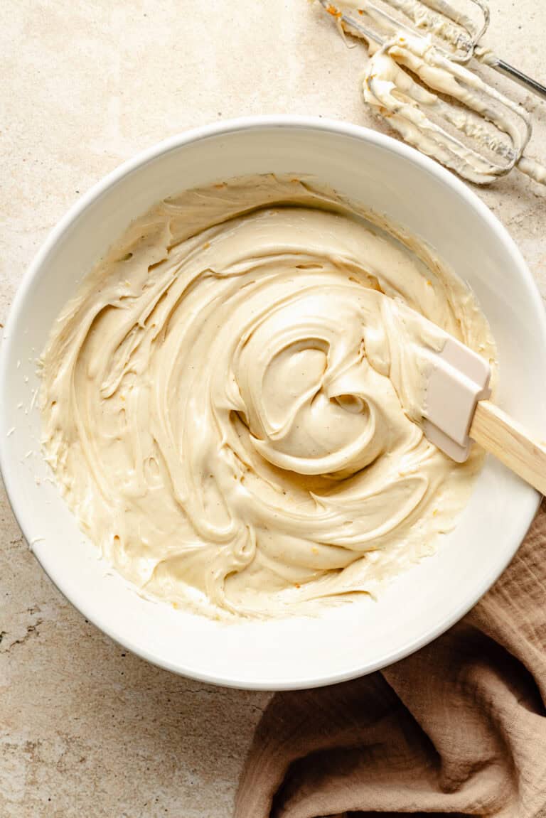 cream cheese frosting in bowl with spatula