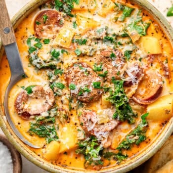 sausage kale and potato soup in bowl with spoon