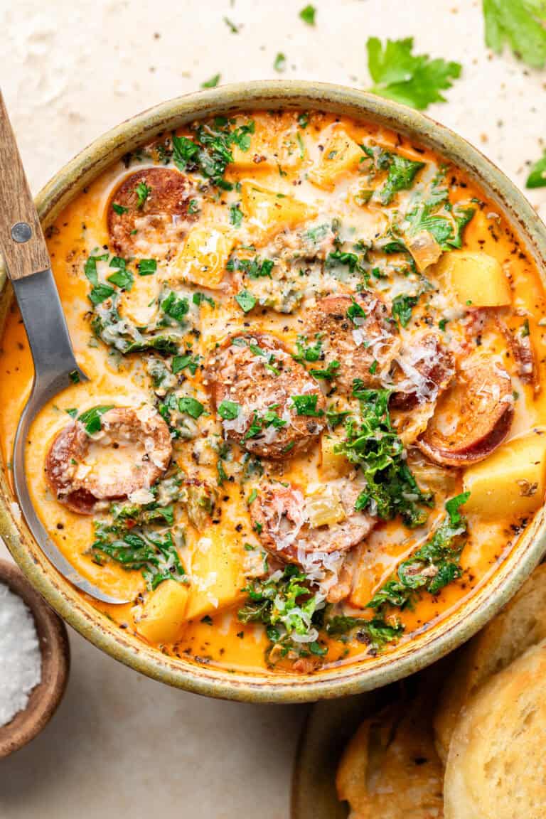 sausage kale and potato soup in bowl with spoon