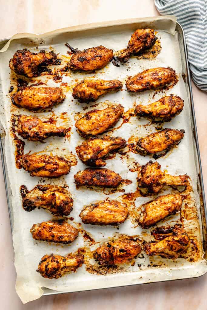 baked wings on parchment lined sheet pan