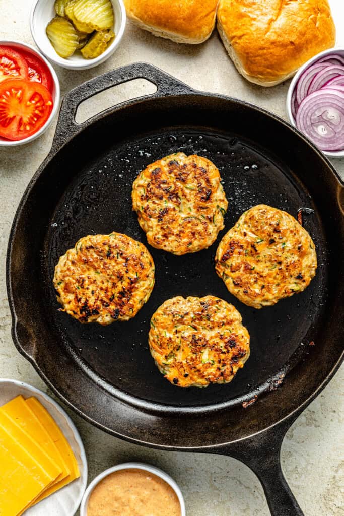 chicken burger patties on skillet