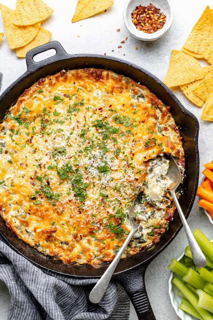 creamy spinach artichoke dip in skillet