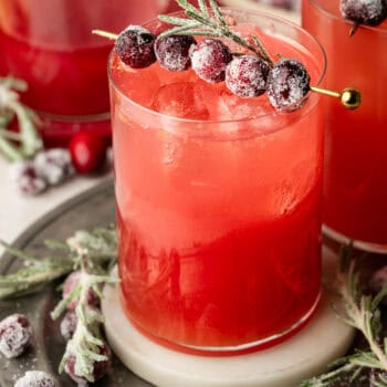 mocktail in glass with sugared cranberries