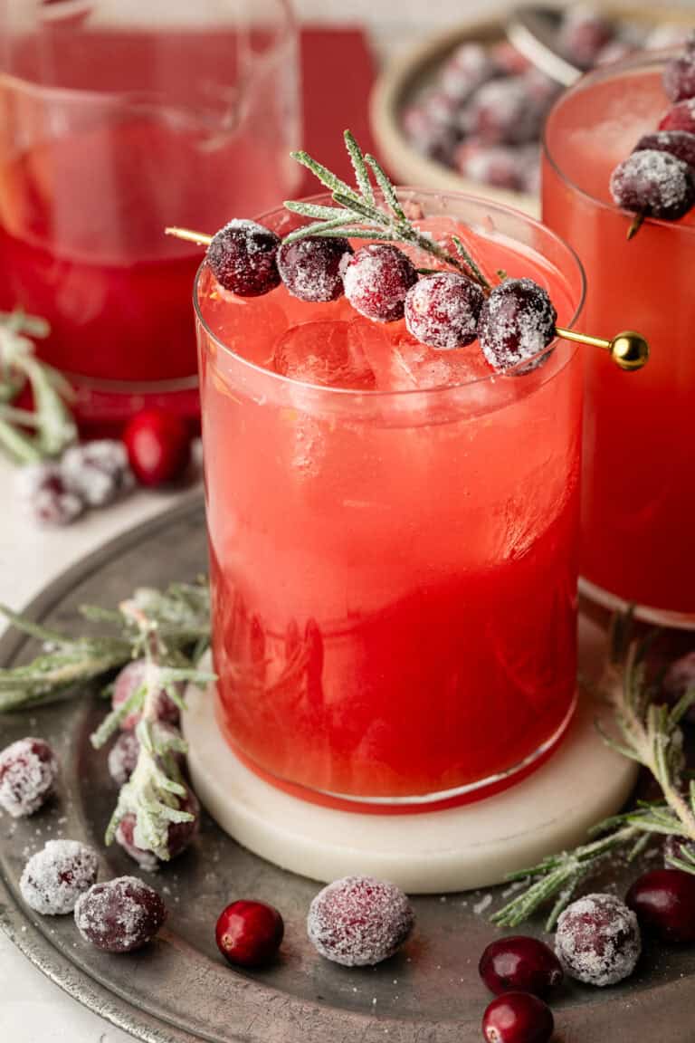 mocktail in glass with sugared cranberries