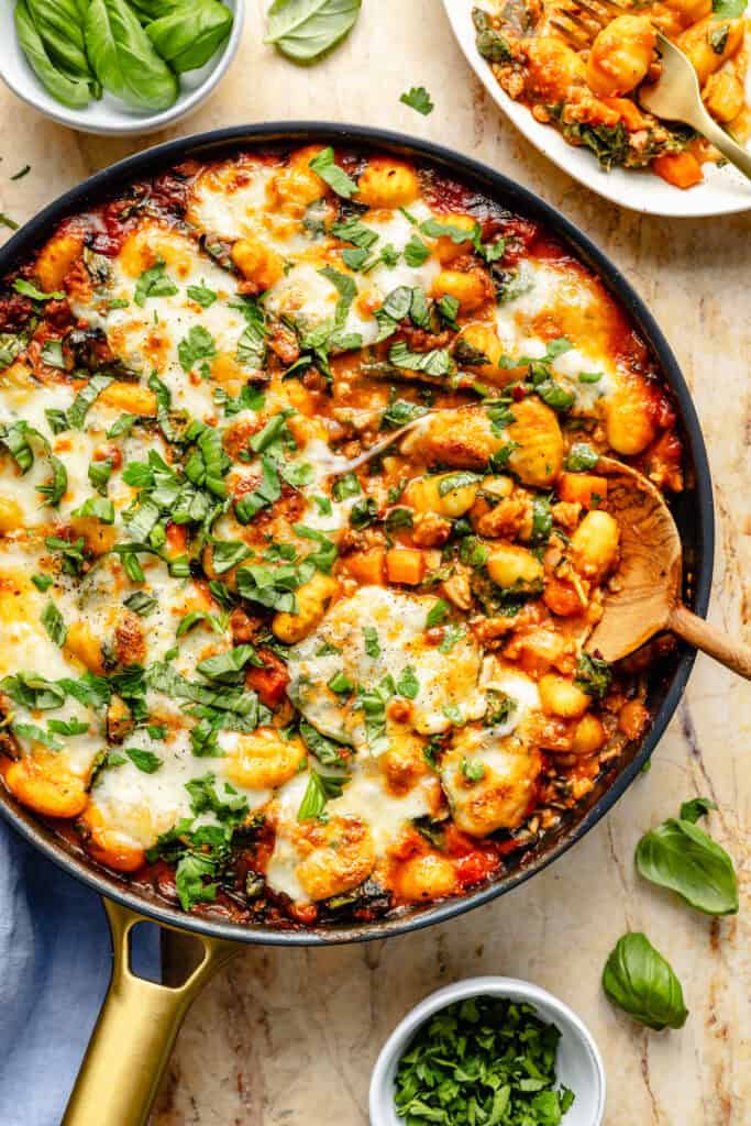 skillet baked gnocchi with wooden spoon