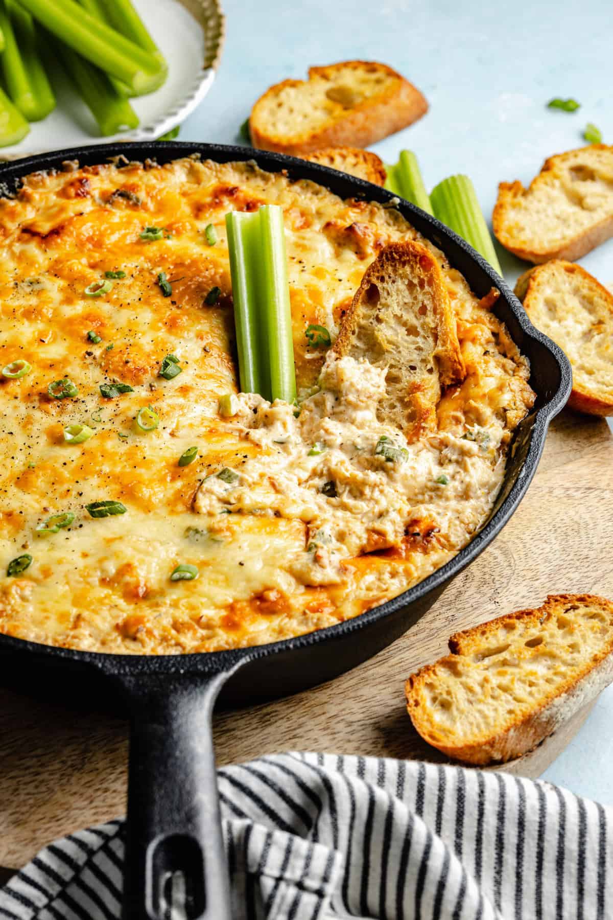 crab dip with celery and bread dipped in