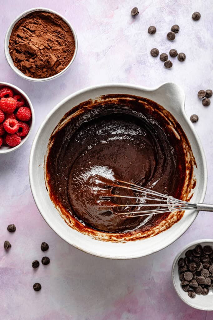 chocolate cake batter in bowl with whisk