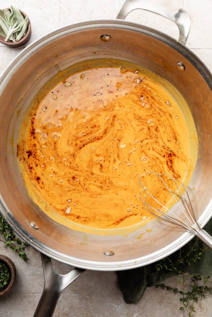 pumpkin sauce in pot with whisk