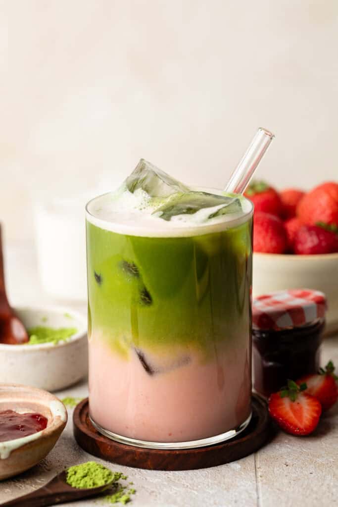 strawberry matcha latte in glass with straw