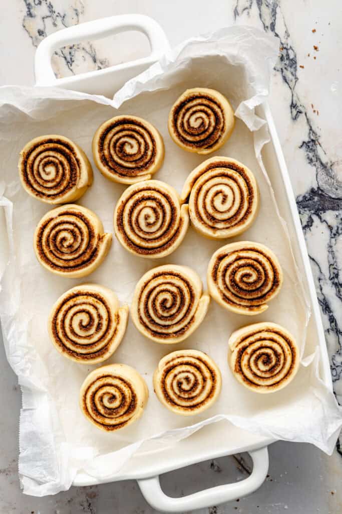 cinnamon rolls in baking dish before rising