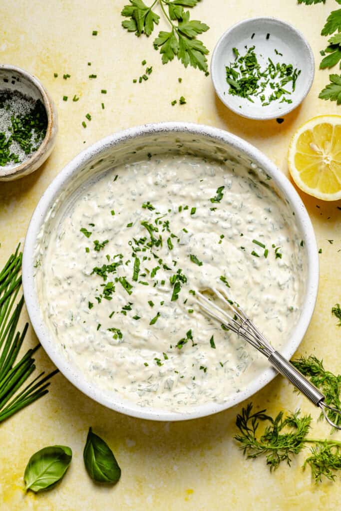 green goddess dressing in bowl with whisk