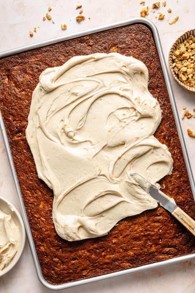 cream cheese being spread over bars