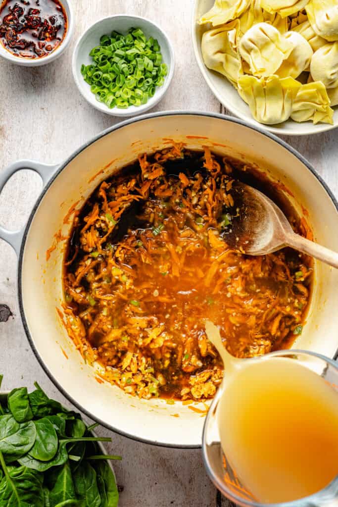 broth being poured into soup
